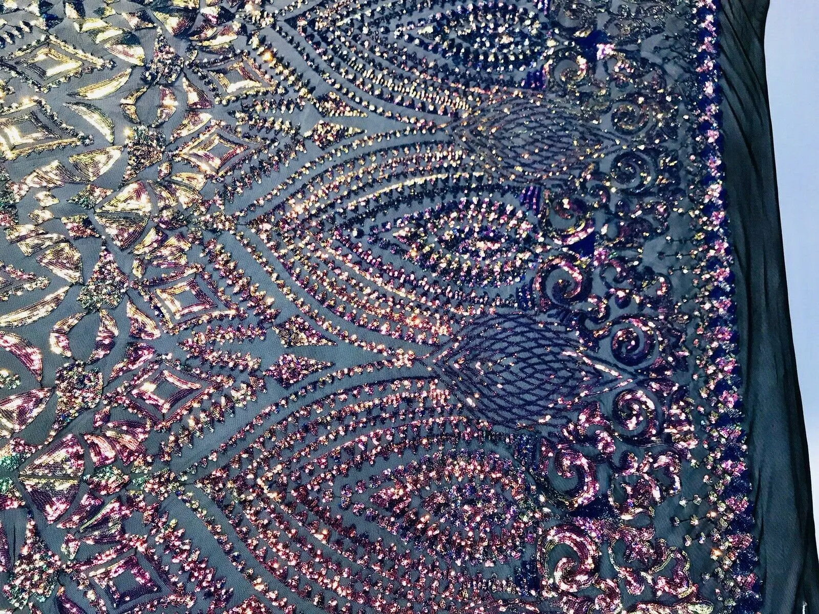 Rainbow iridescent sequin diamond design on a 4 way stretch black mesh-by the yard.